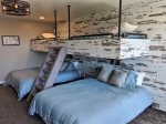 Bottom Level Bedroom w/ 2 Queen Beds and Industrial Bunk holding 2 Twin Beds